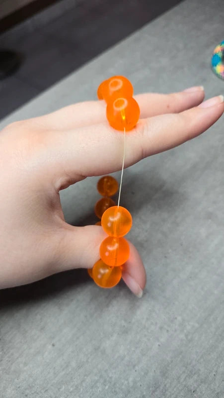 bracelet vintage - neuf - élastique - grosse perles rondes orange translucide - style rétro pop