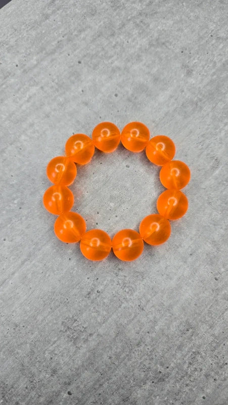 bracelet vintage - neuf - élastique - grosse perles rondes orange translucide - style rétro pop