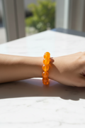 bracelet vintage - neuf - élastique - grosse perles rondes orange translucide - style rétro pop