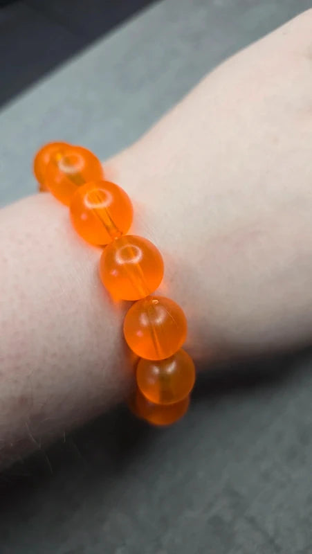 bracelet vintage - neuf - élastique - grosse perles rondes orange translucide - style rétro pop